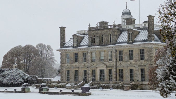 A grand stone mansion in the snow